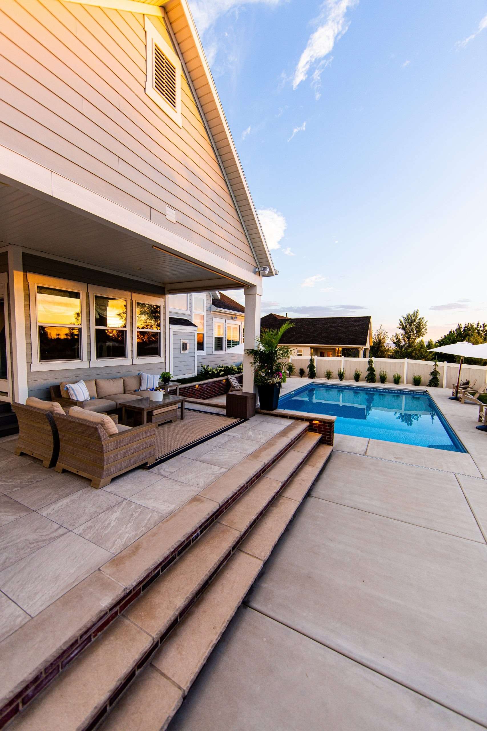 House patio with pool at sunset.