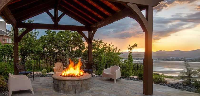 Backyard fire pit at sunset with mountain view.